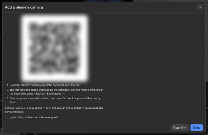 A phone's camera: the guest scans the code and the dialog says she is live. The code is blurred here.